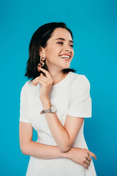 Happy elegant woman in dress laughing isolated on blue — Stock Photo