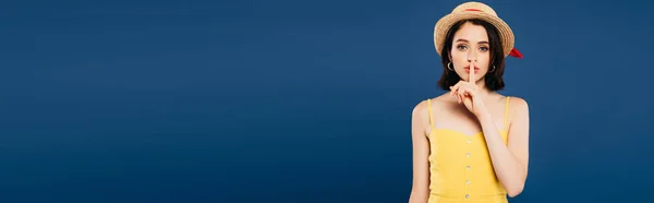 Panoramic shot of girl in straw hat showing shh sign isolated on blue — Stock Photo