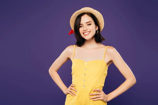 Happy girl in straw hat with hands on hips isolated on purple — Stock Photo