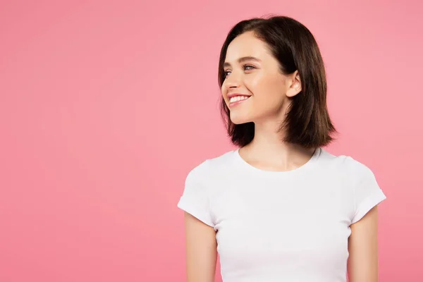Smiling pretty girl looking away isolated on pink — Stock Photo