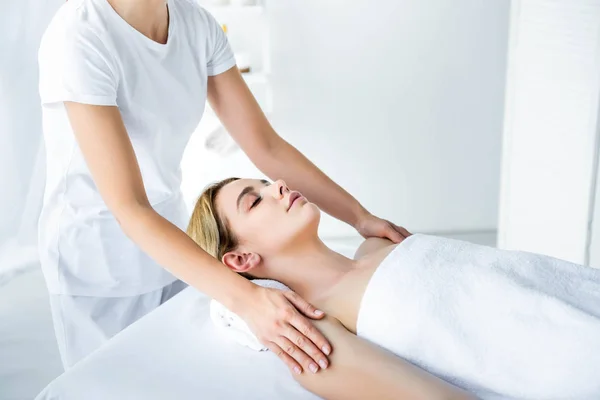 Cropped view of masseur doing hand massage to attractive woman — Stock Photo