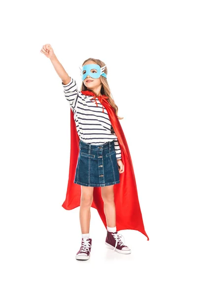 Full length view of kid in mask and hero cloak holding fist up isolated on white — Stock Photo