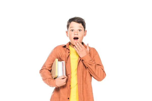 Front view of shocked kid holding books isolated on white — Stock Photo