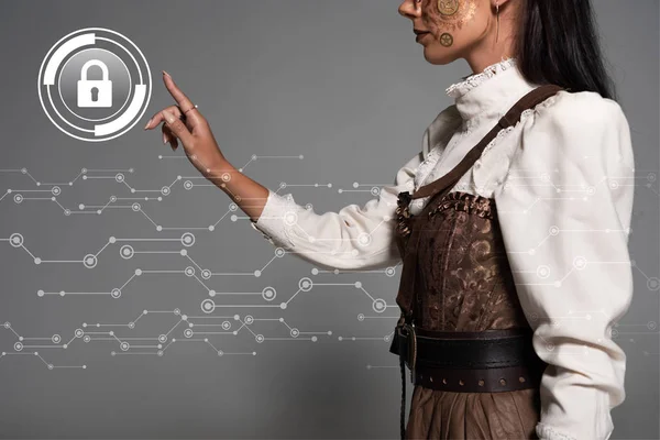 Cropped view of steampunk young woman pointing with finger at lock illustration — Stock Photo