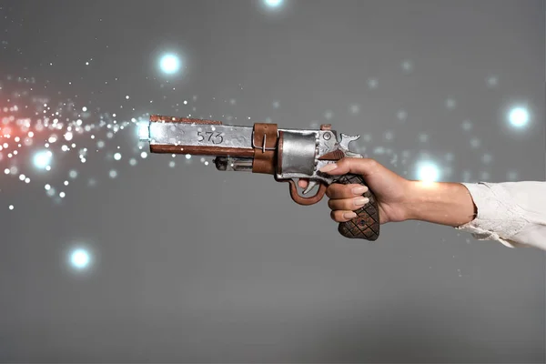 Cropped view of woman holding vintage revolver isolated on grey — Stock Photo