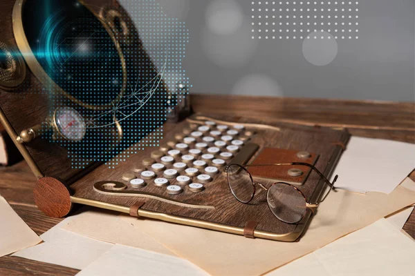 Steampunk laptop with data illustration, glasses and documents on wooden table isolated on grey — Stock Photo