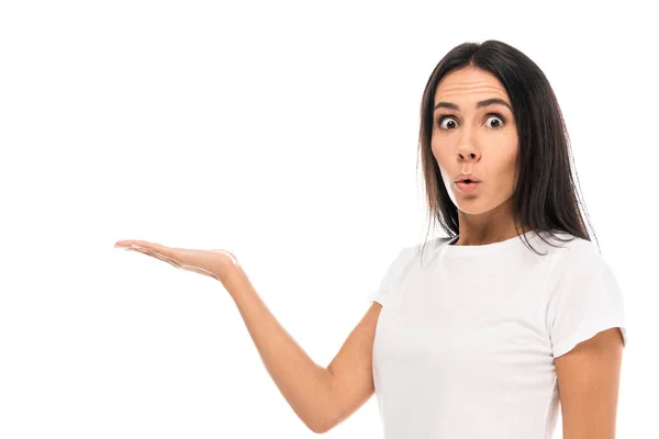 Young surprised woman pointing with hand while looking at camera isolated on white — Stock Photo