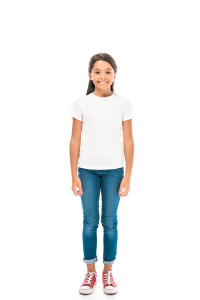 Happy kid in blue jeans standing isolated on white — Stock Photo