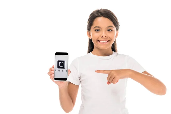 KYIV, UKRAINE - SEPTEMBER 3, 2019: happy kid pointing with finger at smartphone with uber app on screen isolated on white — Stock Photo