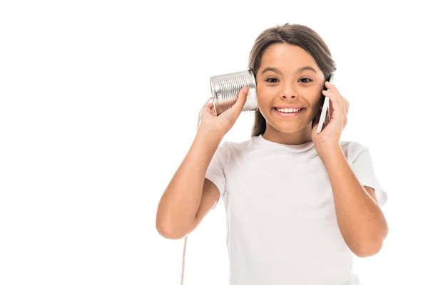 Garoto feliz falando no smartphone e brincando com lata isolada no branco — Fotografia de Stock