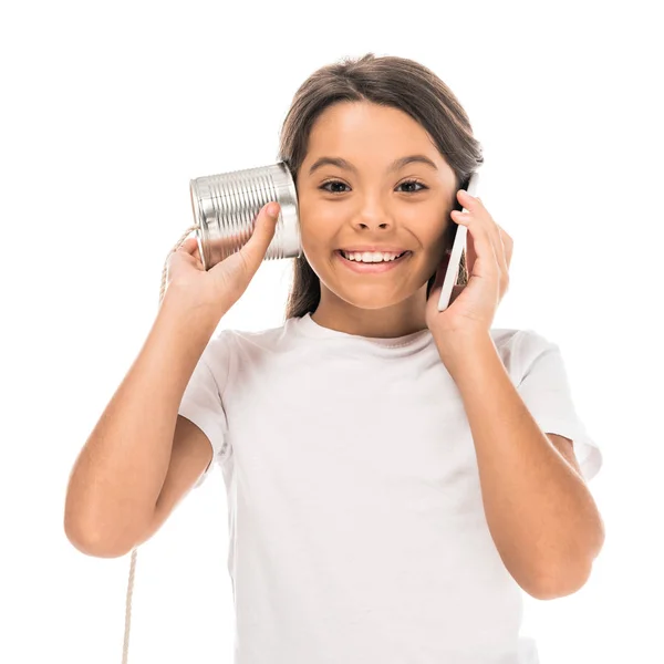 Lindo niño hablando en el teléfono inteligente y jugando con lata aislado en blanco — Stock Photo