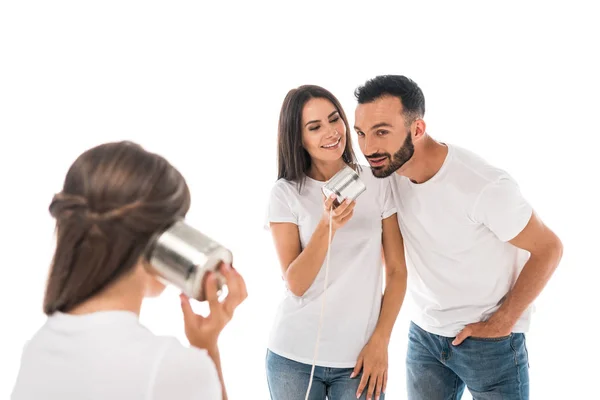 Back view of child holding tin can near cheerful parents isolated on while — Stock Photo