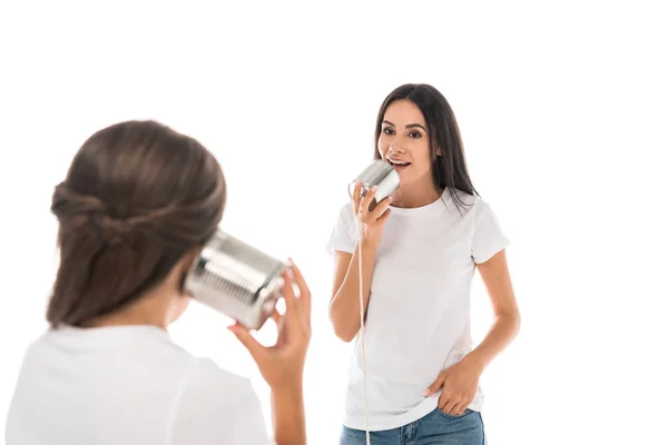 Back view of kid holding tin can and playing with mother isolated on while — Stock Photo