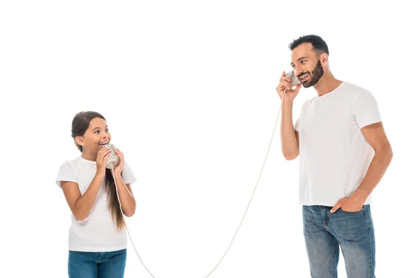 Happy kid holding tin can and playing with cheerful father isolated on while — Stock Photo