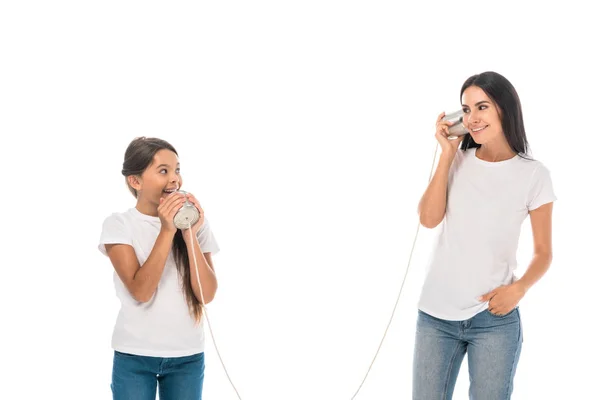 Happy mother and daughter playing tin cans isolated on white — Stock Photo