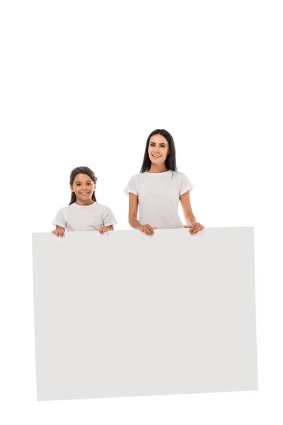 Happy mother and daughter standing with placard isolated on white — Stock Photo