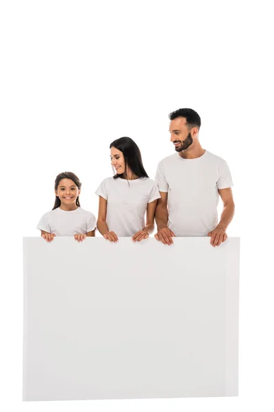 Niño feliz de pie con pancarta cerca de la madre y el padre aislado en blanco - foto de stock