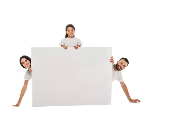 Cheerful parents and happy daughter near blank placard isolated on white — Stock Photo