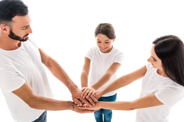 Vista aerea della famiglia positiva mettendo insieme le mani isolate sul bianco — Foto stock