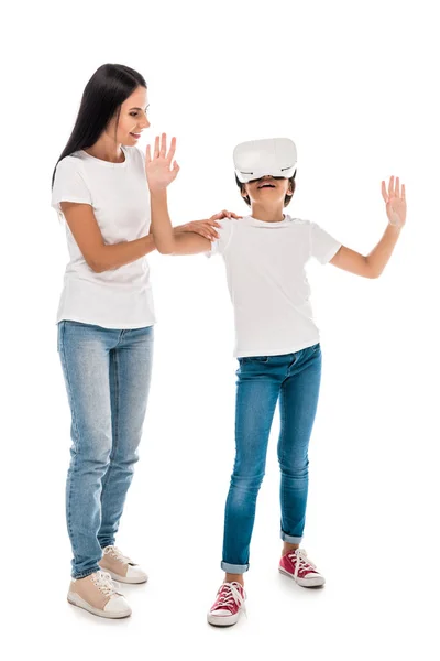 Mother standing with kid in virtual reality headset isolated on white — Stock Photo