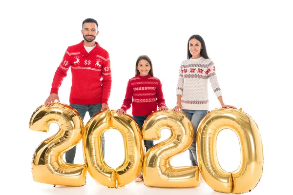 Cheerful parents and kid in sweaters standing near air balloons isolated on white — Stock Photo