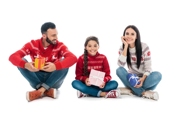Happy family in sweaters holding gifts on white — Stock Photo