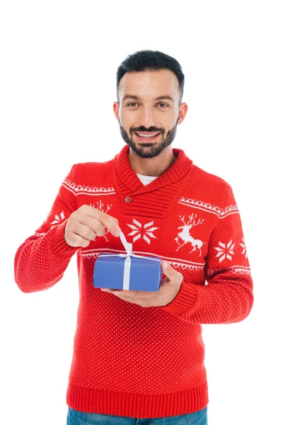 Happy bearded man touching ribbon on present isolated on white — Stock Photo