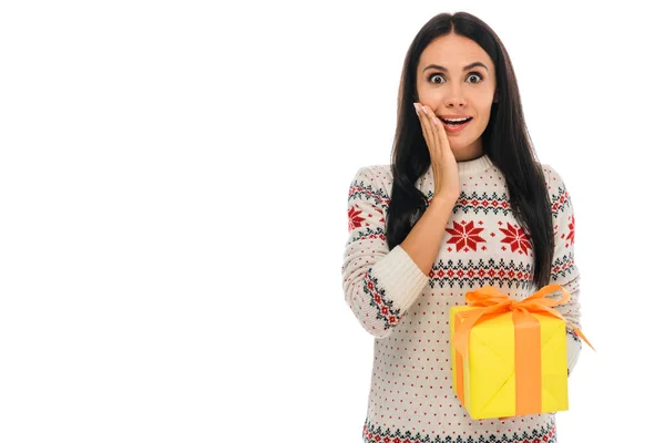 Excited woman holding yellow present isolated on white — Stock Photo