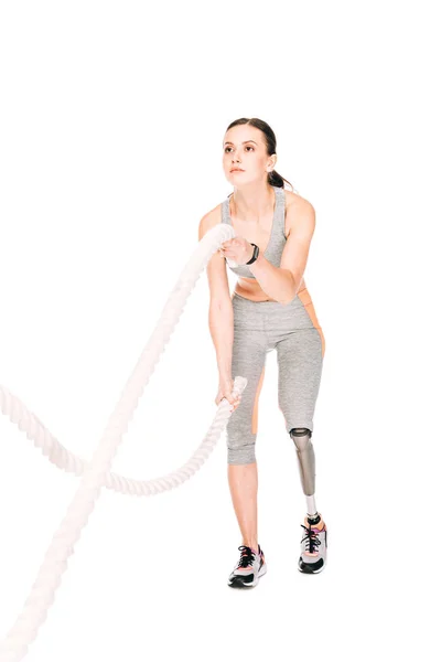 Full length view of disabled sportswoman training with ropes isolated on white — Stock Photo