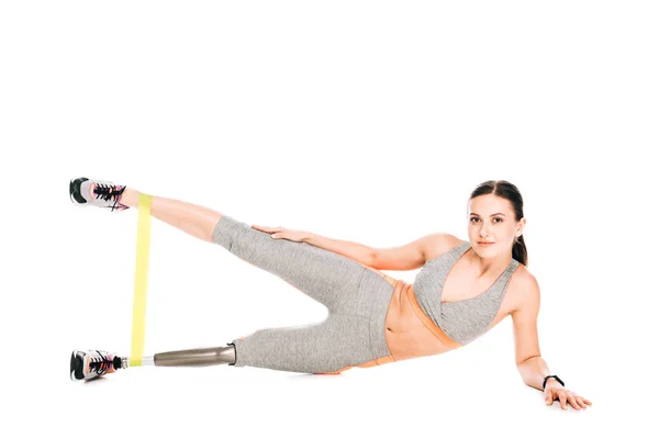 Disabled sportswoman with prosthetic leg training with resistance band — Stock Photo