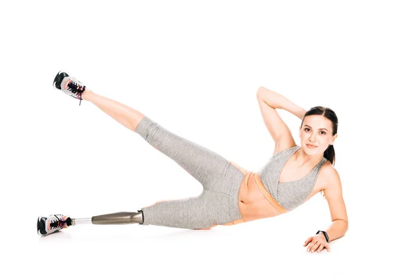 Disabled sportswoman with prosthesis training isolated on white — Stock Photo