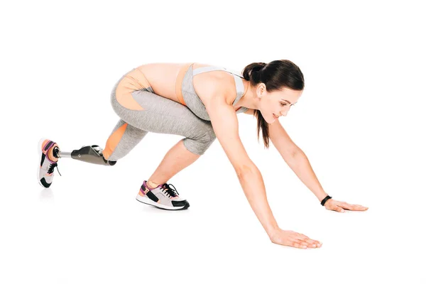 Disabled sportswoman with prosthesis training isolated on white — Stock Photo