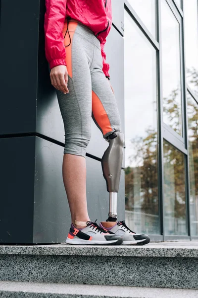 Partial view of disabled sportswoman with prosthesis on street — Stock Photo