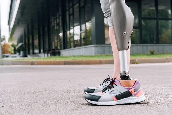 Partial view of disabled sportswoman with prosthesis on street — Stock Photo