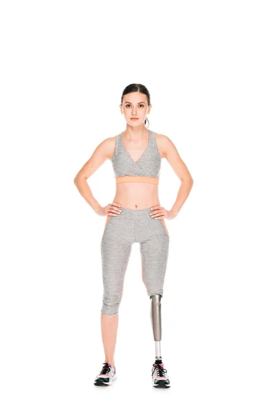 Full length view of disabled sportswoman standing with hands on hips isolated on white — Stock Photo