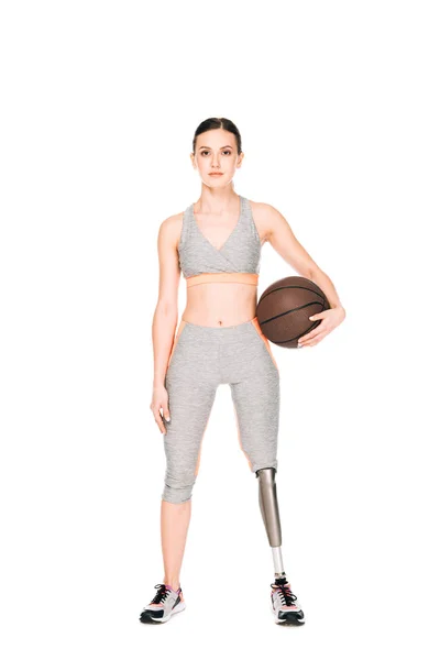 Full length view of disabled sportswoman holding basketball ball isolated on white — Stock Photo