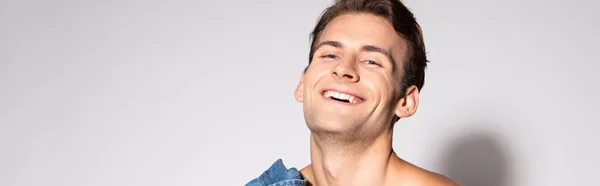 Panoramic shot of happy man smiling on white — Stock Photo