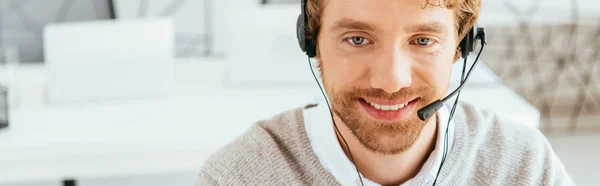 Panoramic shot of happy and bearded operator in brokers agency — Stock Photo