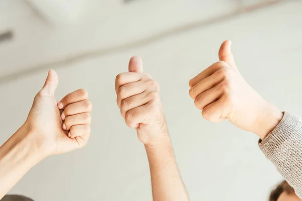 Cropped view of brokers showing thumbs up — Stock Photo