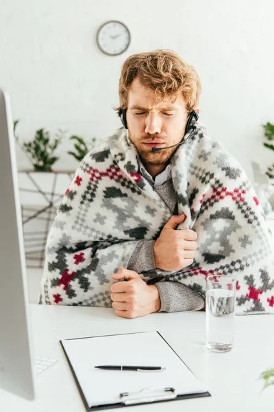 Courtier barbu malade enveloppé dans une couverture dans le bureau — Photo de stock