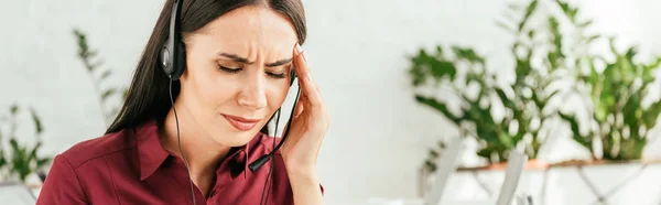 Panoramic shot of tired broker with migraine touching head in office — Stock Photo