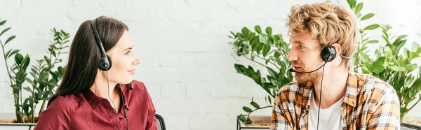 Panoramic shot of happy brokers looking at each other in office — Stock Photo