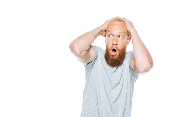 Handsome shocked bearded man in grey t-shirt, isolated on white — Stock Photo