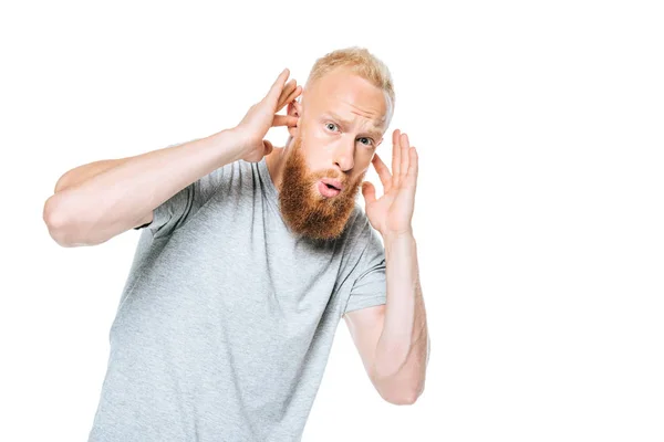 Worried bearded man in grey t-shirt closing his ears from loud sound, isolated on white — Stock Photo