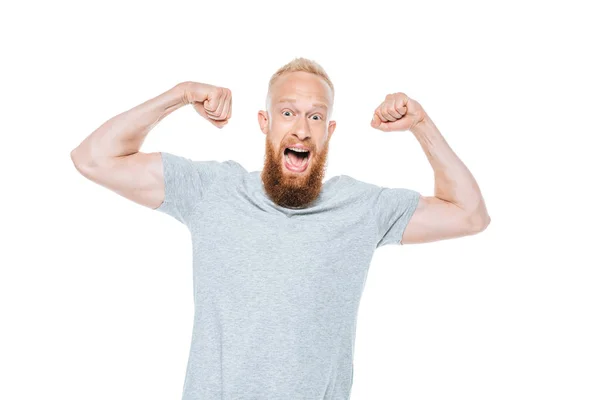 Bel homme excité en t-shirt gris gagner quelque chose, isolé sur blanc — Photo de stock