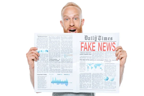 Aufgeregter Mann liest Zeitung mit Fake News, isoliert auf weiß — Stockfoto