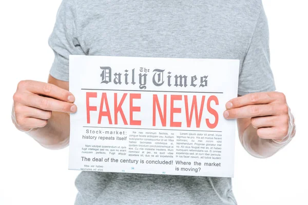 Teilansicht eines Mannes, der Zeitung mit Fake News zeigt, isoliert auf Weiß — Stockfoto