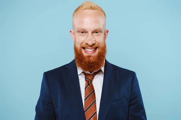 Веселий бородатий бізнесмен в костюмі, ізольований на синьому — стокове фото