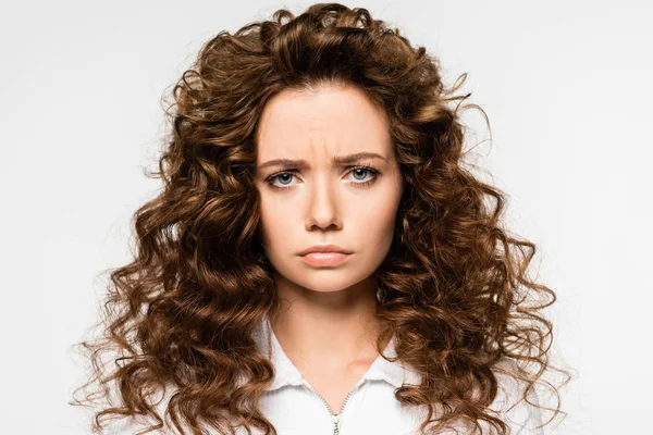 Attractive upset curly girl in white t-shirt, isolated on white — Stock Photo