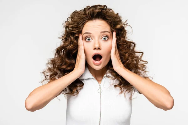 Shocked curly girl gesturing in white t-shirt, isolated on white — Stock Photo